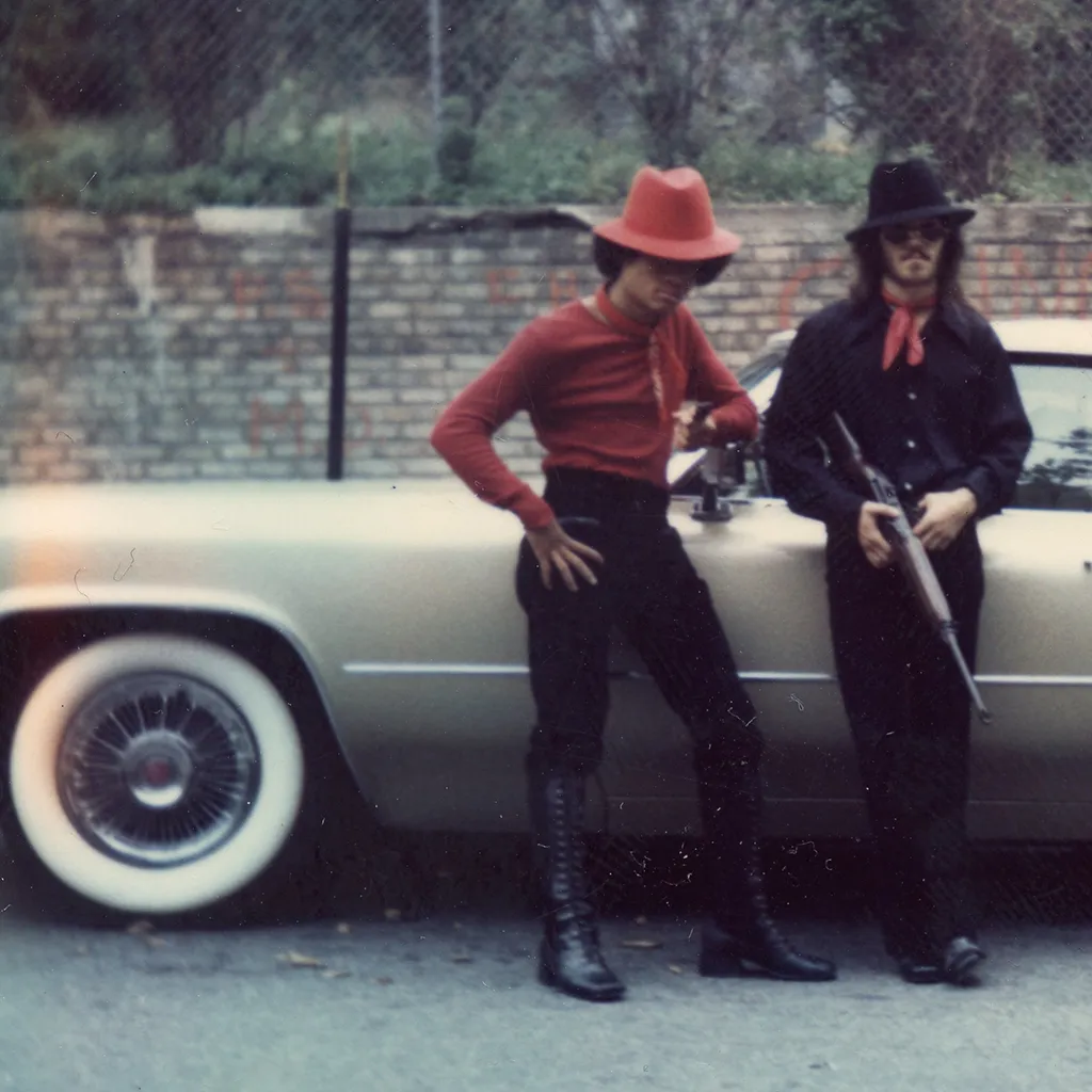 Chino Bicicleta and Pepe posing with firearms in Mount Pleasant